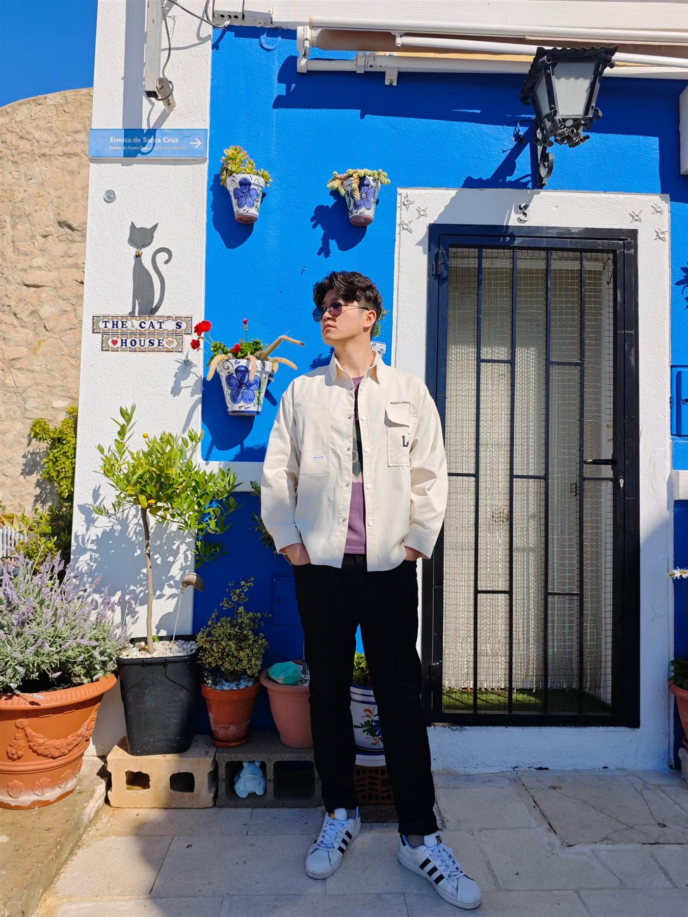 Siyuan travelling beside a blue cat house
